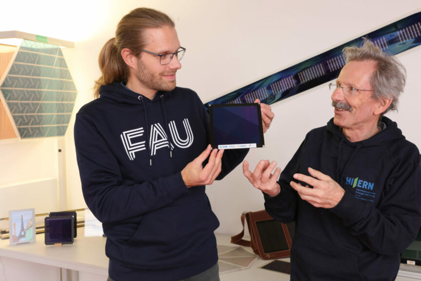 Dr. Andreas Distler (l.) and Dr. Hans-Joachim Egelhaaf(r.) with the organic photovoltaic module with new world record efficiency in the laboratory of the “Solar Factory of the Future" The organic photovoltaic module with new world record efficiency of 14.46%. Copyright: Kurt Fuchs / HI ERN